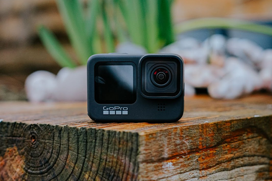 A small, compact action camera in nature