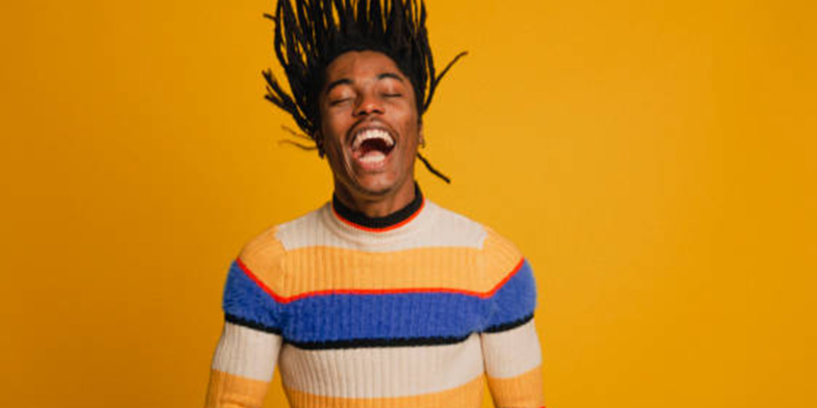 Man in colorful striped clothes is laughing