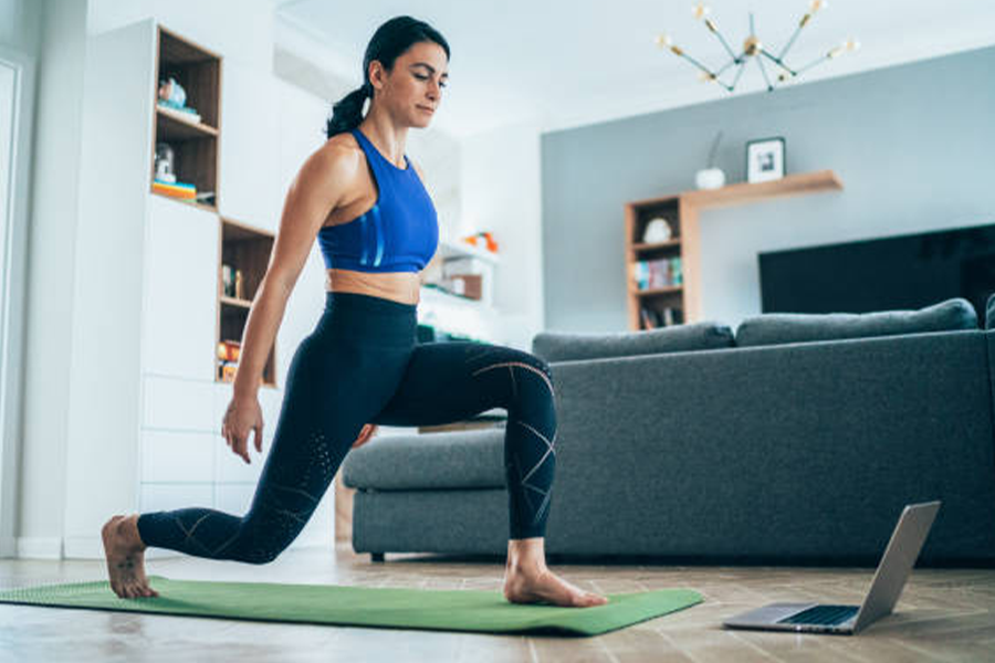 Woman working out at home with high-waisted leggings on