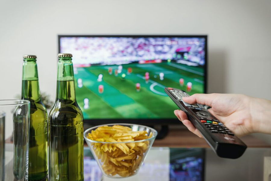 A sports fan streaming a soccer game on their smart TV