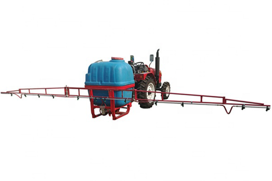A boom sprayer mounted on a tractor