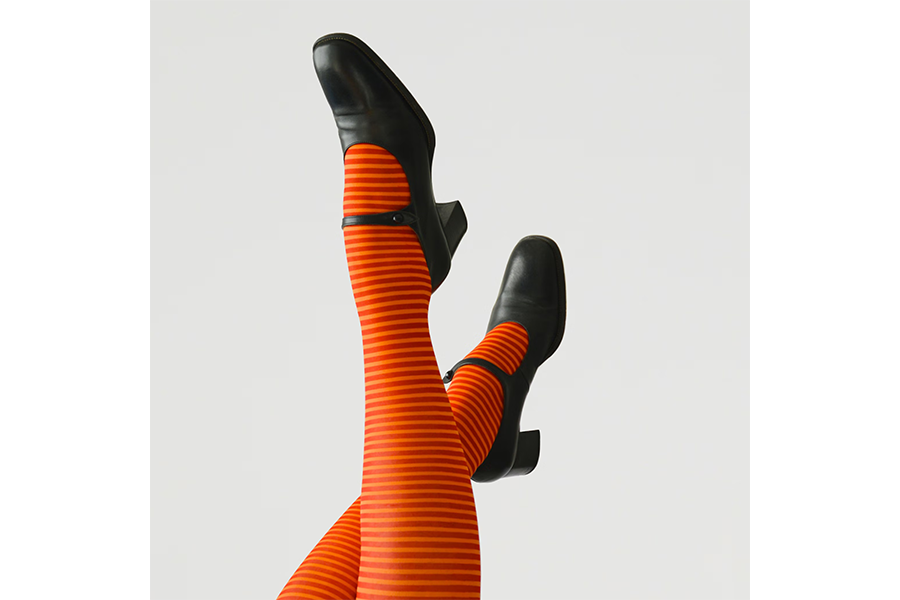 A pair of striped socks worn with black leather heels