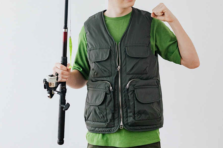 Young man posing in a dark green base layer T-shirt