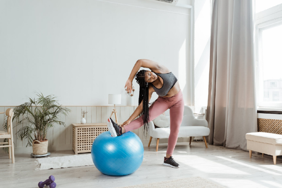 Woman doing exercise with a ball at home