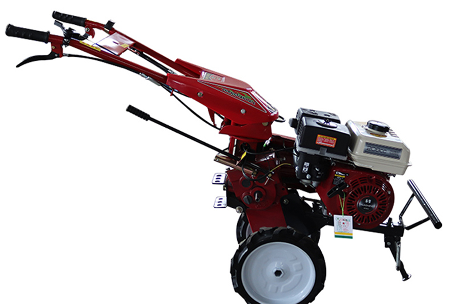 A gasoline cultivator with a red stainless steel frame