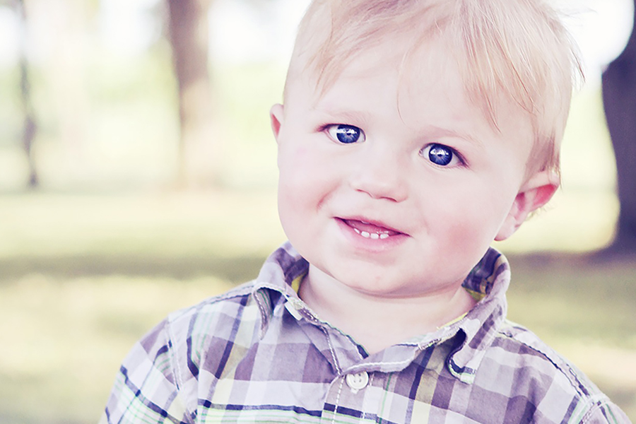Smiley cute toddler rocking a plaid shirt