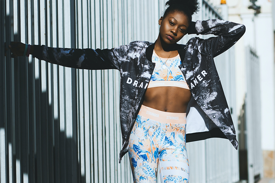 Black female model rocks post-workout jacket and matching set