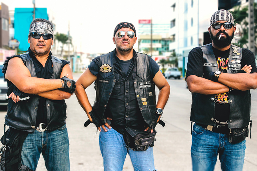 Three men wearing biker leather vest jacket on denim
