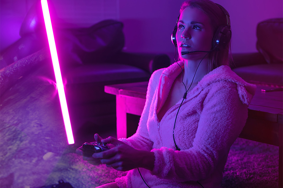 Lady in pink using gaming headsets while gaming