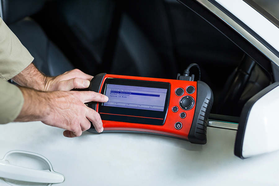 Man using fingers to scroll through Autel diagnostic tool