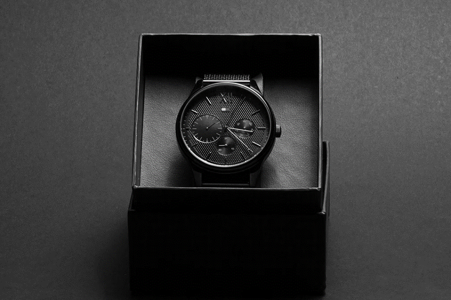 Chronograph watch in black paperboard packaging