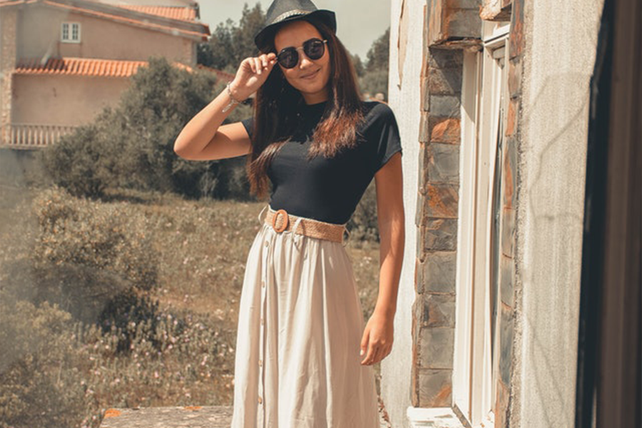 A woman wearing a maxi skirt and a black top