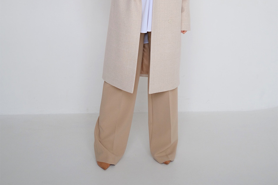 Plus-size woman wearing light brown palazzo pants