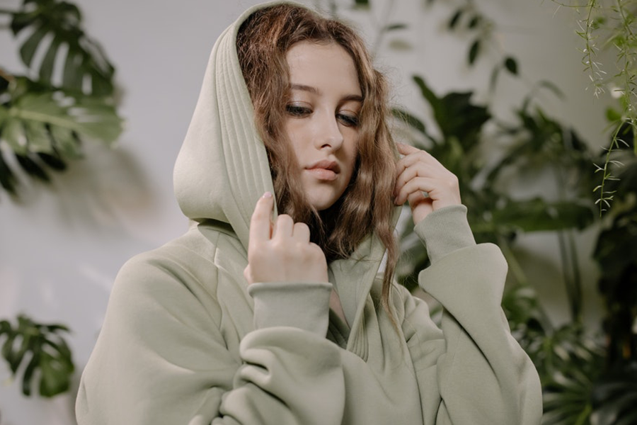 Young lady posing in a khaki hoodie