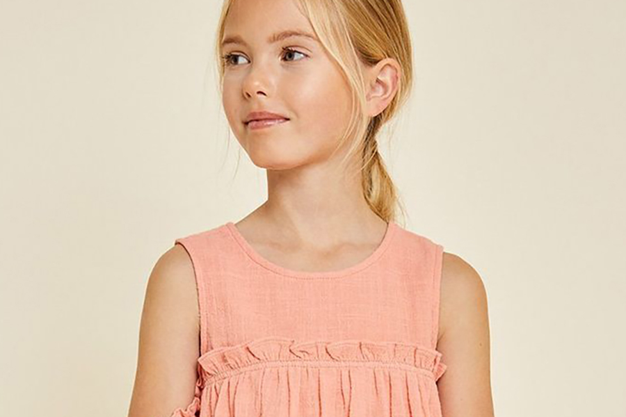 Cute little girl wearing a pink crinkle gauze dress
