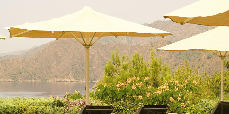 Several patio umbrellas adorning a beautiful backyard in Turkish countryside