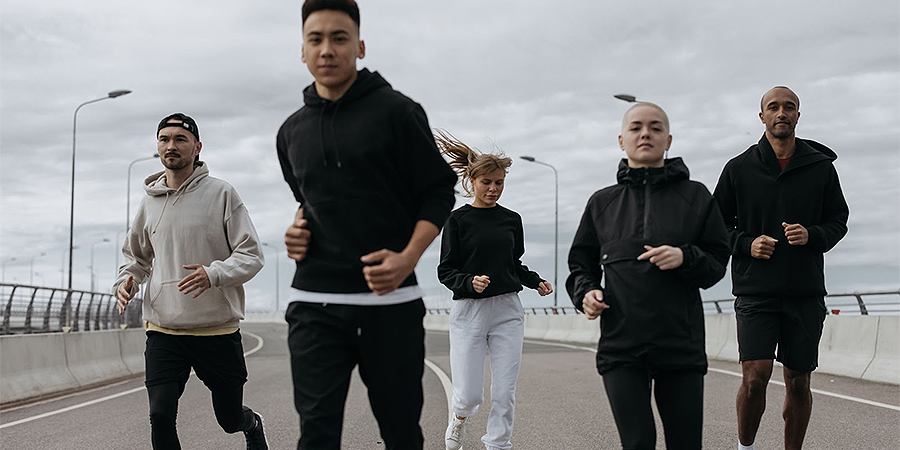 A group dressed in joggers running
