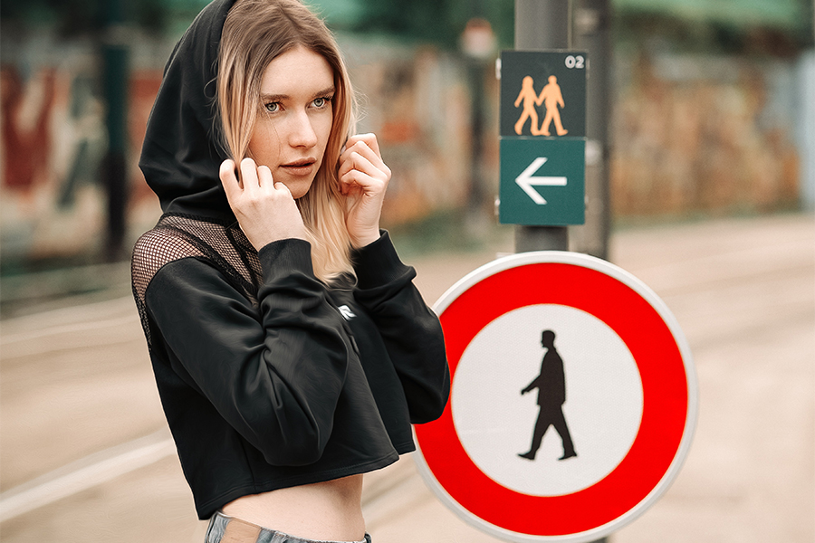 Lady posing on the street with a black cropped hoodie