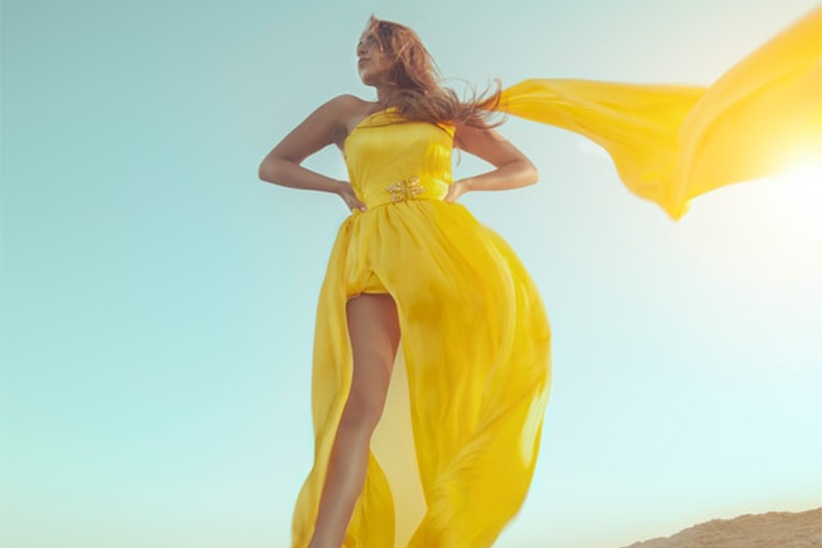 A woman wearing a yellow high-low dress