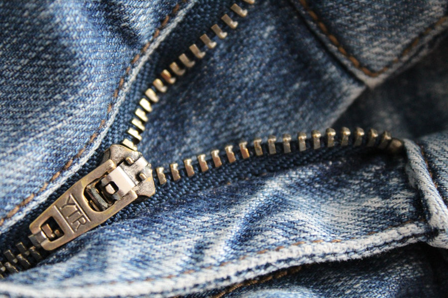 Close up view of blue denim with a fly zipper