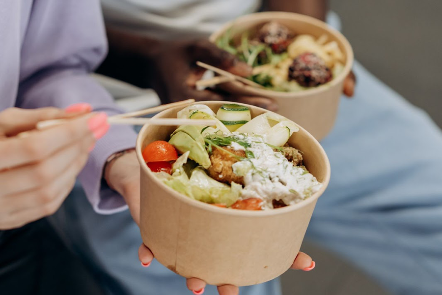 Two people eating healthy food in bowls