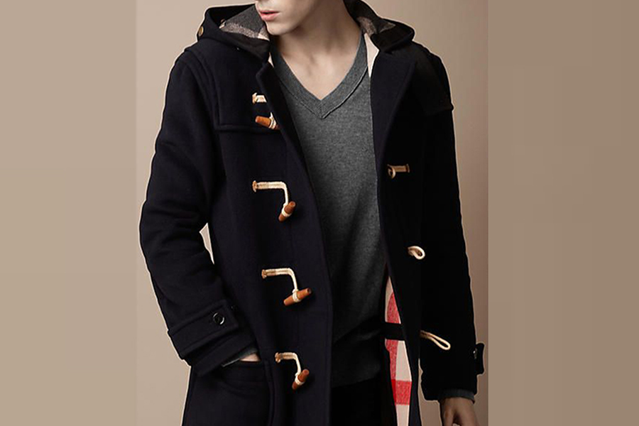 Young man wearing a coat with brown toggle buttons