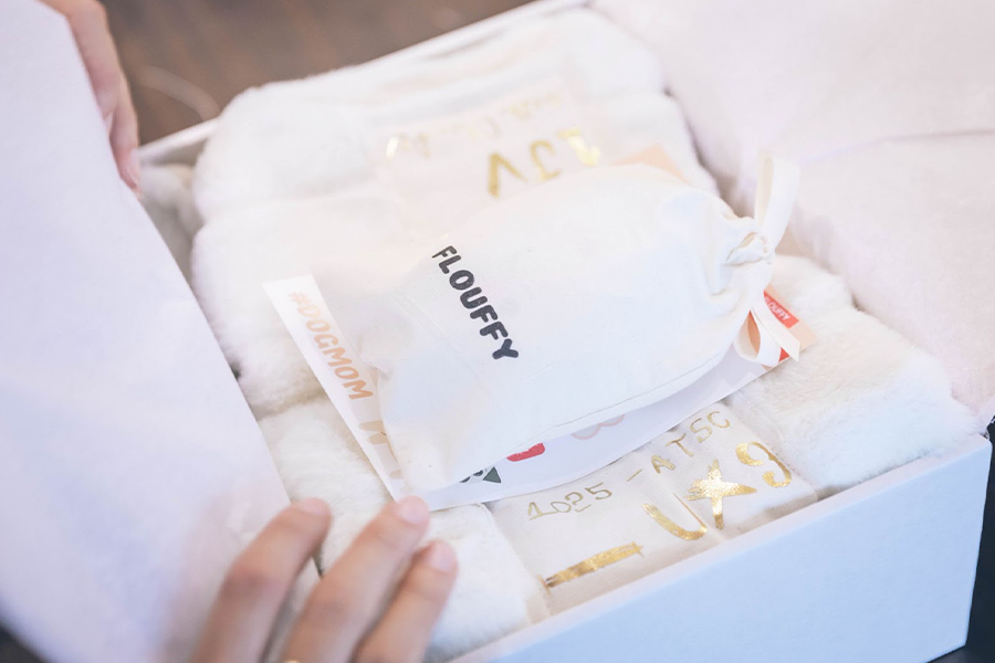 Small white drawstring bag inside a gift box