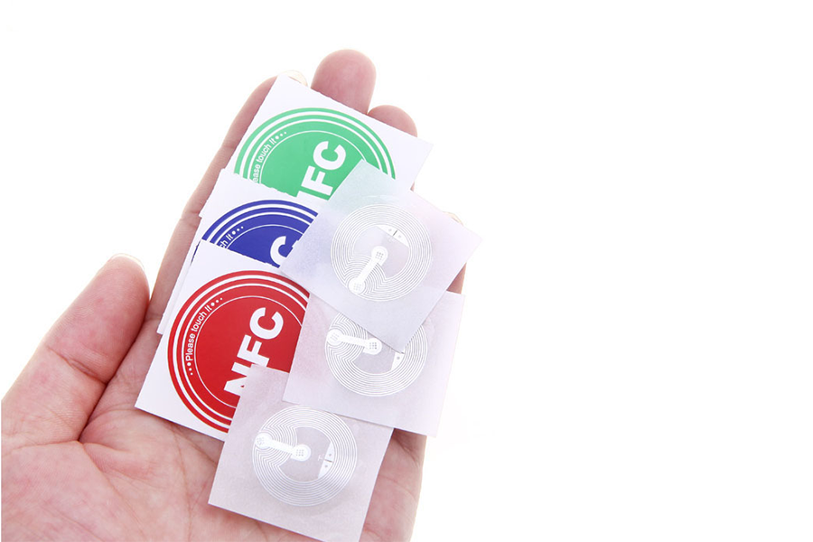 Hand holding waterproof NFC tag sticker