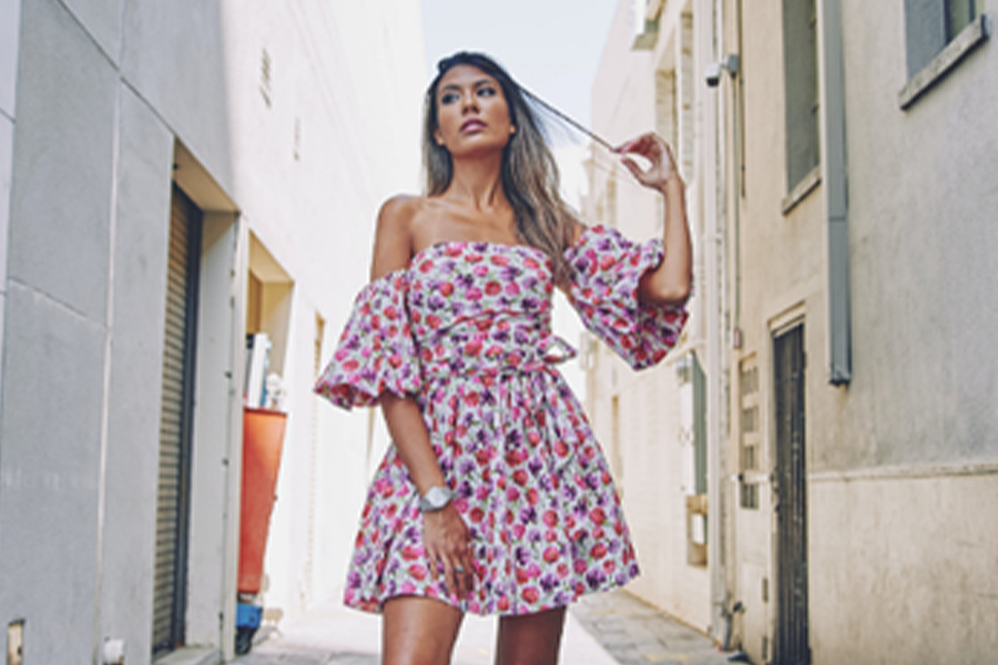 Woman in pink and white floral off shoulder skater dress