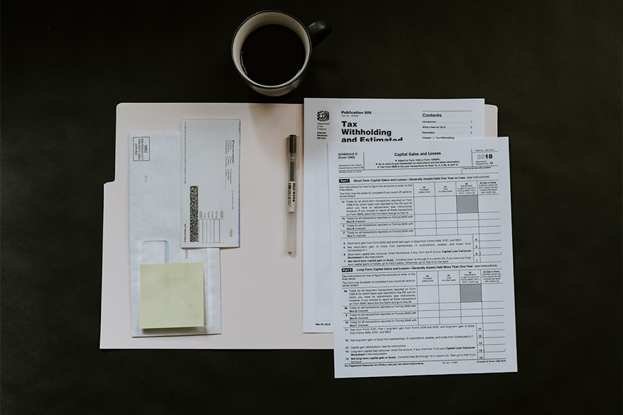Empty tax forms on a desk next to coffee cup