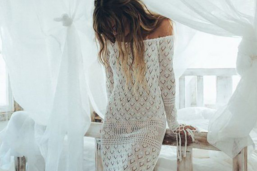Model rocking long crochet white off-shoulder dress