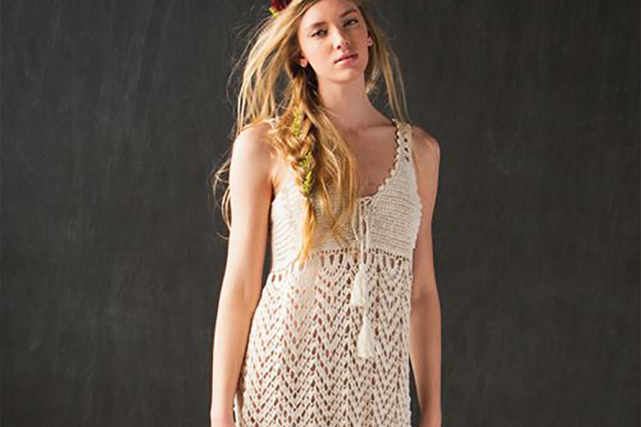 Woman rocking cream-colored crochet empire waist dress