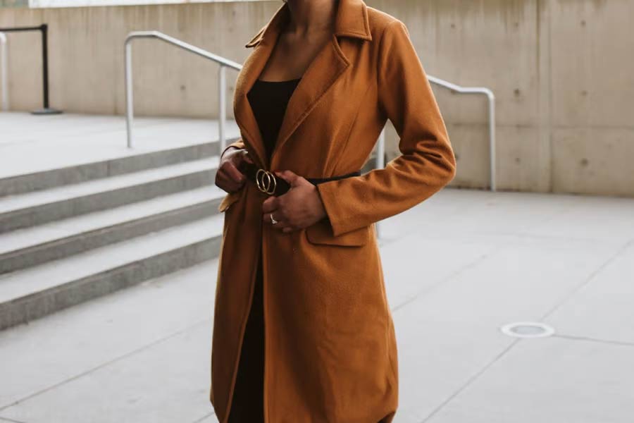 A woman wearing a brown trench coat