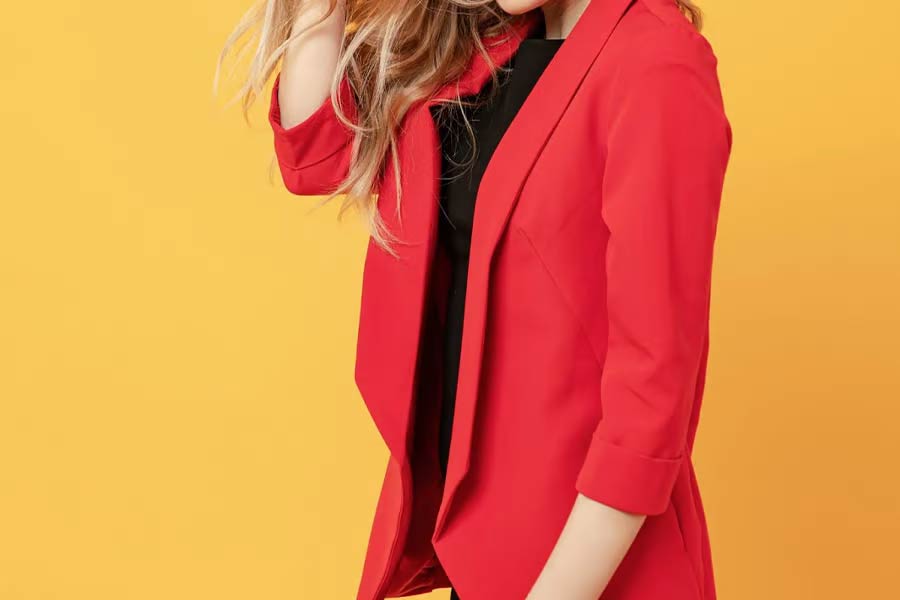 A woman wearing a red color blazer