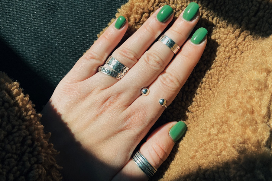 hand with solid green nail polish