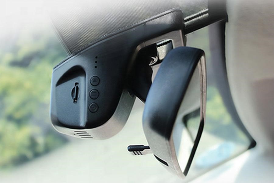 Mini dashcam installed behind a rearview mirror