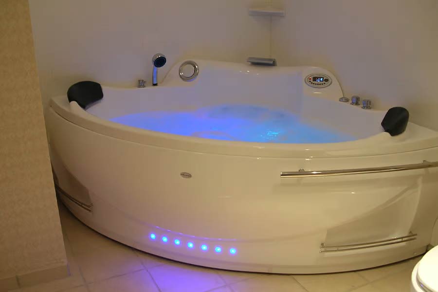 Whirlpool with a lighting system in a bathroom