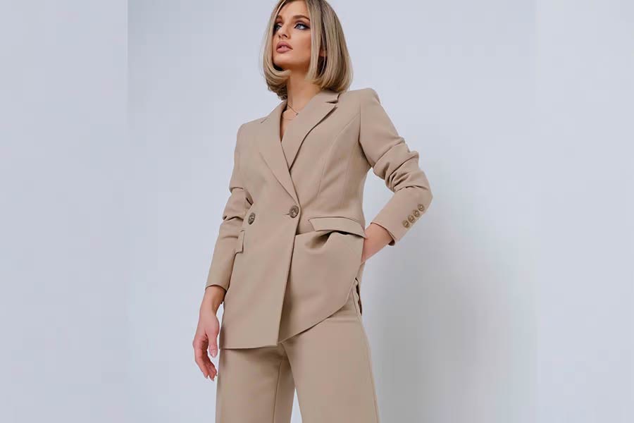 Woman rocking a light brown suit and pants