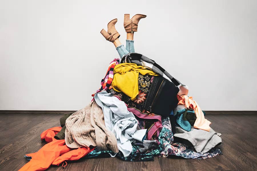 Woman’s legs out of a pile of clothes