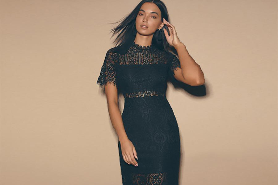 A dark-skinned woman in a lace after-party dress