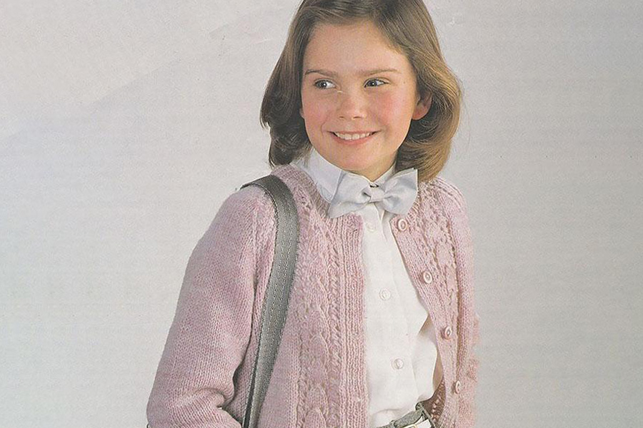 A girl in a light pink vintage knitted sweater