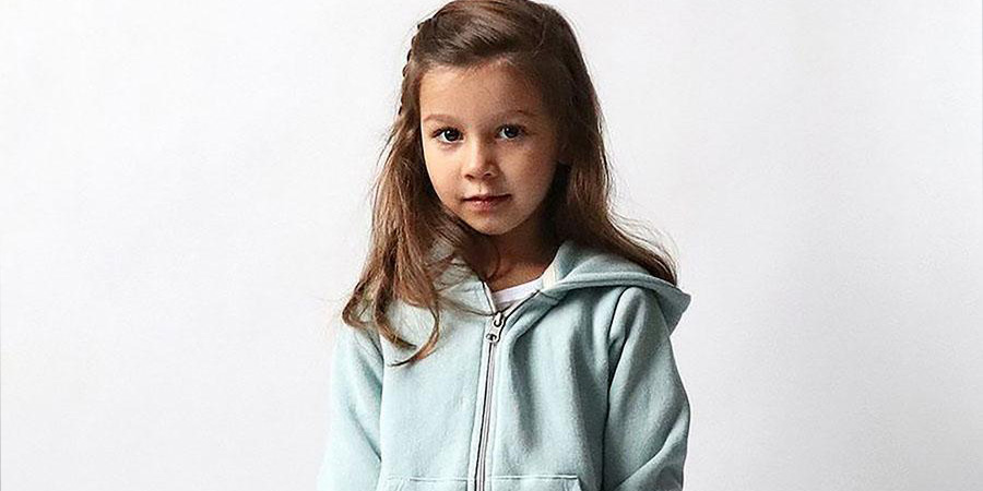 A little girl in a light blue hoodie