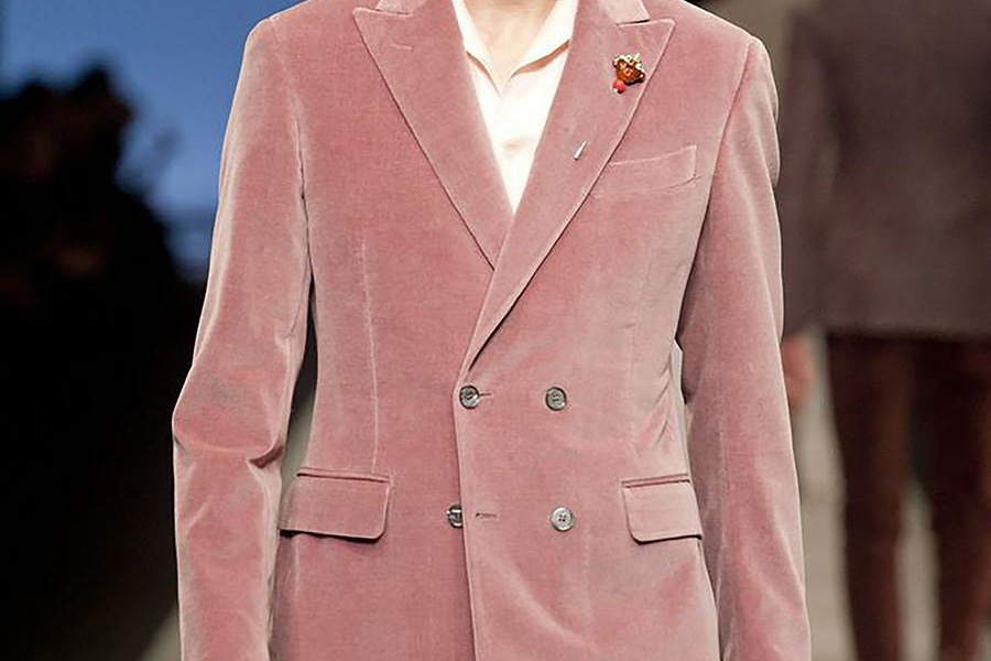 A man in a pink plush velvet jacket