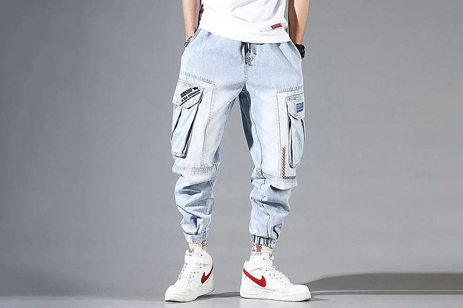 A man in blue cargo denim trousers with elasticized ankles