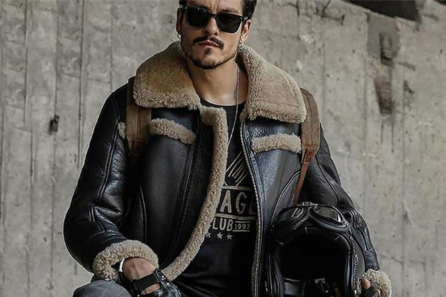 A man wearing a black and brown aviator jacket