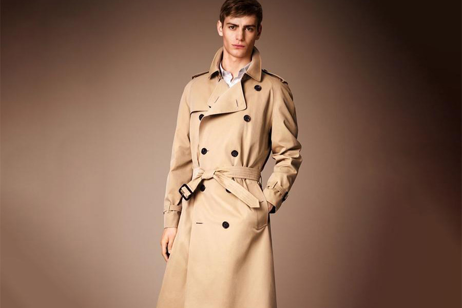 A man wearing a cream colored trench coat