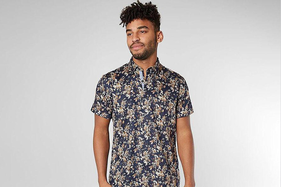 A man wearing a shirt with floral imprint