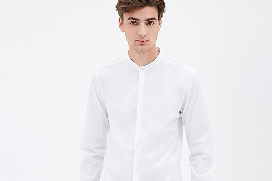 A man wearing white band collar shirt