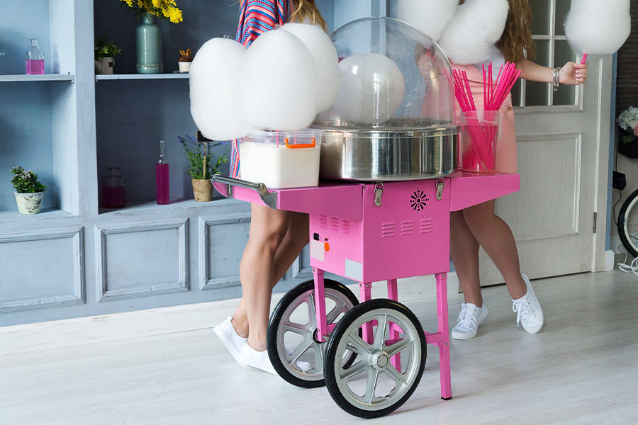 a pink commercial cotton candy machine spinning out candies