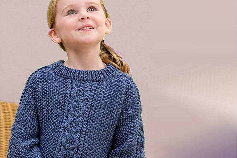 A young girl wearing a blue sweater